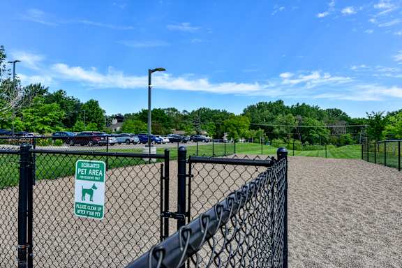 A sign on a fence indicates a pet area.