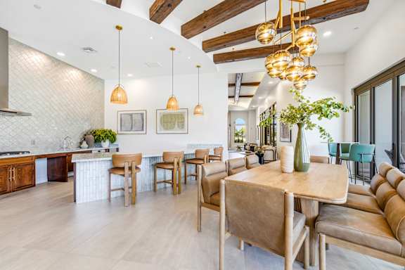 A modern dining room with a wooden table and chairs.