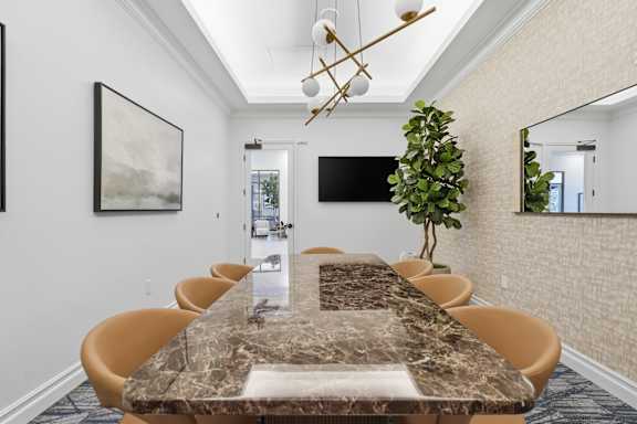 A conference room with a long table and chairs.