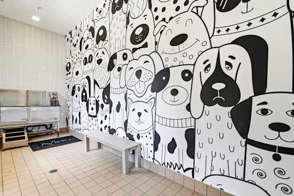 A wall of dog drawings in a room.