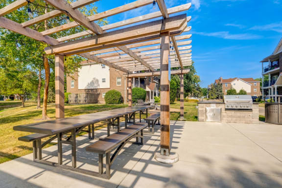 a picnic area with benches and a pergola