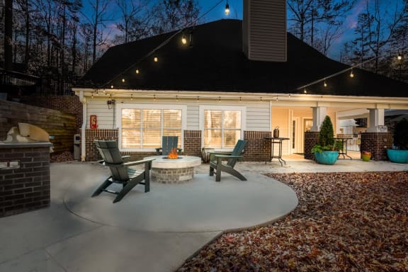 a circular concrete patio with a fire pit in the middle