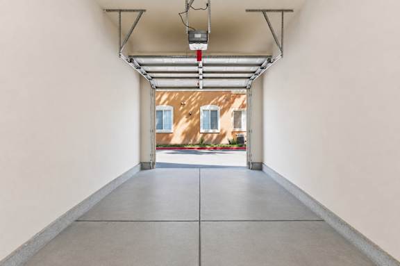 A long hallway with a red light hanging from the ceiling.