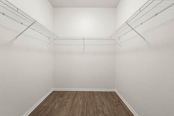 Empty room with white walls and wooden floor.