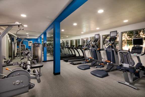 Gym with cardio equipment and weights in a building with windows at Ascend2300, Carlsbad, 92008