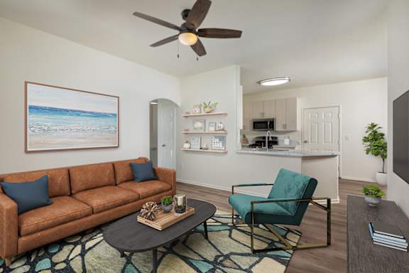 A living room with a brown couch, a green chair, and a coffee table.