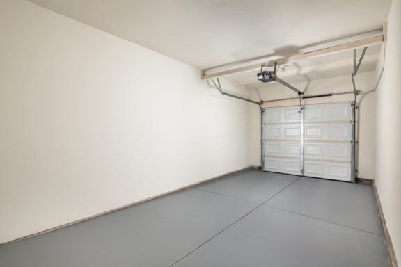 an empty garage with white walls and white garage doors