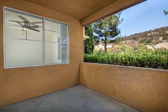 a patio with a window and a mountain view