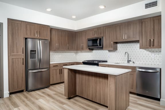 a kitchen with a large island and stainless steel appliances at Citron, California, 92805