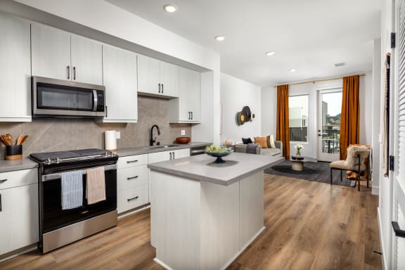 Kitchen with a center island and a stove and a microwave at VORA LUX, Mission Valley