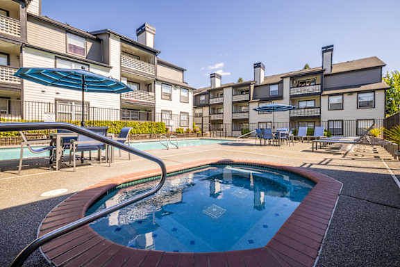 A swimming pool in front of apartment buildings.