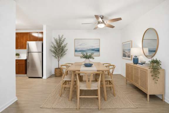 A dining room with a wooden table and chairs.