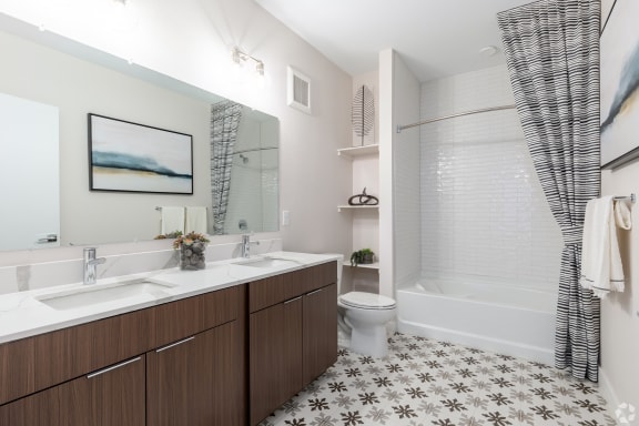a bathroom with a shower and a sink and a toilet