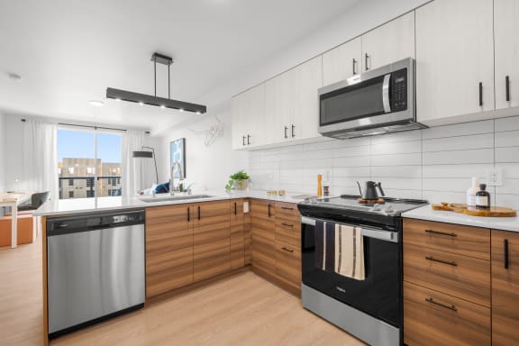 a kitchen with white cabinets and a wooden floor