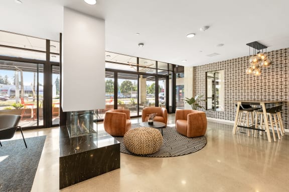 a living room with a fireplace and glass doors at Ion Town Center, Shoreline