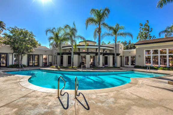 a mansion with a swimming pool and palm trees