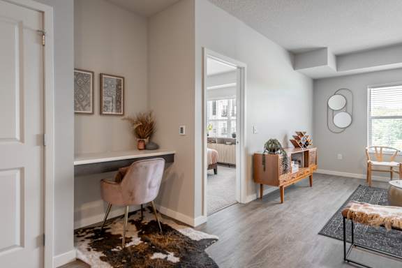 A room with a desk and a chair in it.
