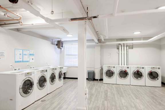 A row of washing machines in a laundry room.