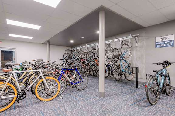 A room full of bicycles is an electric bicycle charging area.