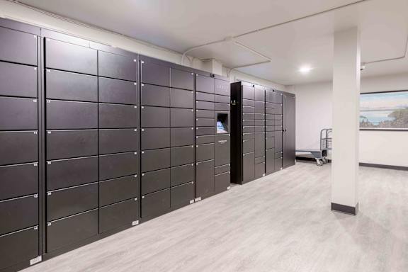 A row of black filing cabinets in a room.