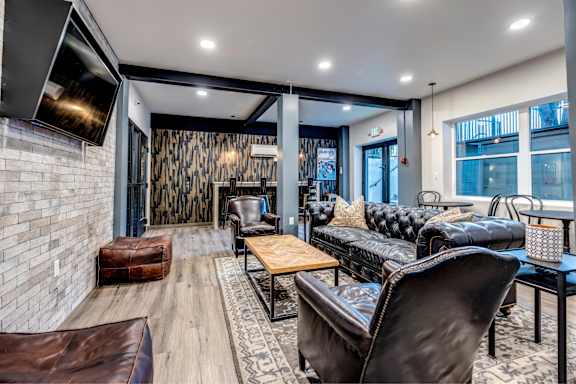 A modern living room with a leather couch and a wooden coffee table. at Lock Vista, Seattle, WA, 98107