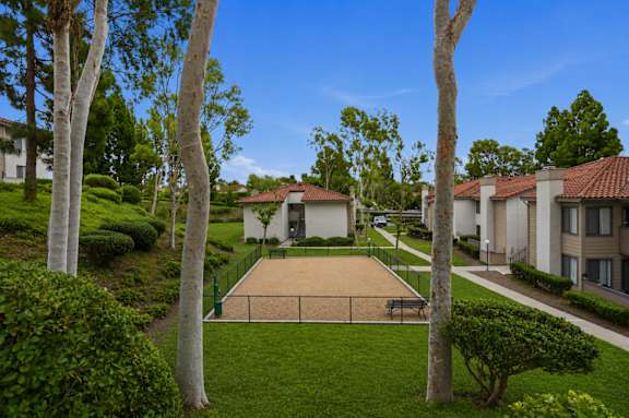 A park surrounded by trees and houses.