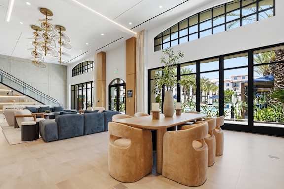 A large room with a long table and chairs.