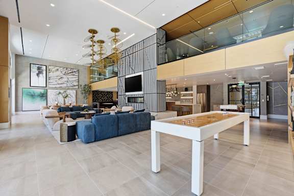 A modern living room with a blue sofa and a wooden coffee table.