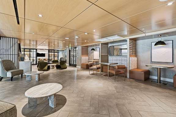 A modern lounge area with wooden floors and furniture.