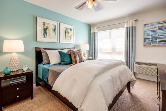 a bedroom with a large bed and a ceiling fan