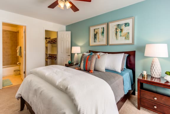 a bedroom with a large bed and a ceiling fan