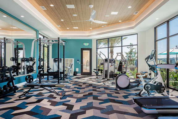 Gym with a variety of exercise equipment and windows