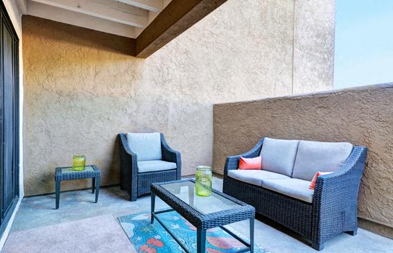 A patio with a sofa, chair, and table at The Casas Apartments, California, 92126