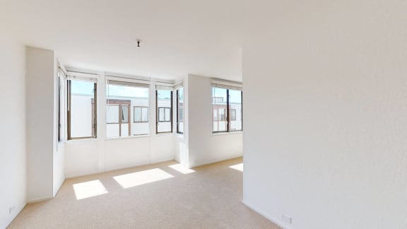 a bedroom with a large window and white walls