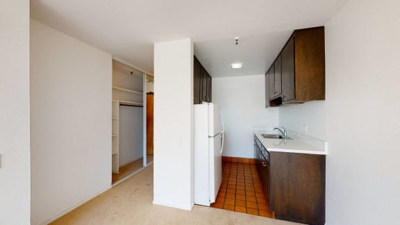 a kitchen with a white refrigerator freezer next to a sink