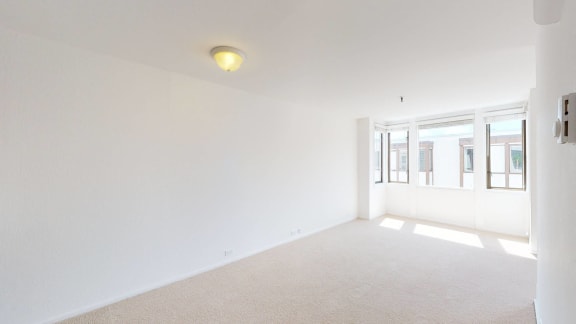 a bedroom with white walls and white carpet