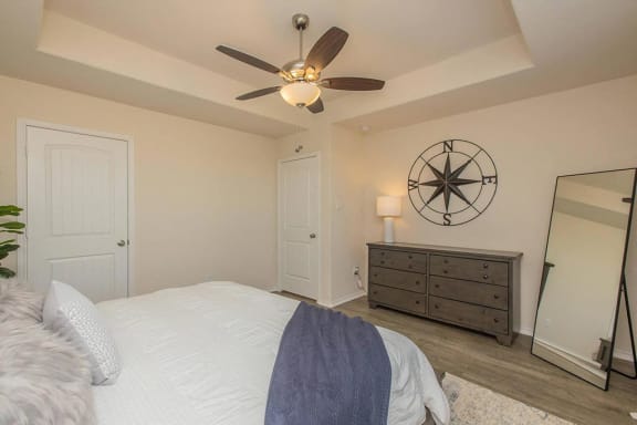 a bedroom with a bed and a ceiling fan