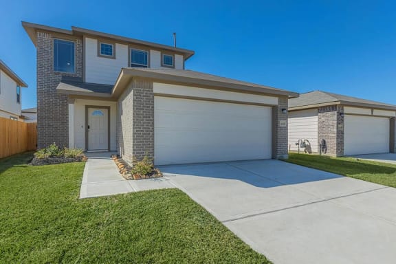 a house with a white garage door and a driveway