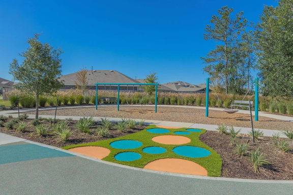 a playground at a park with trees and playground equipment