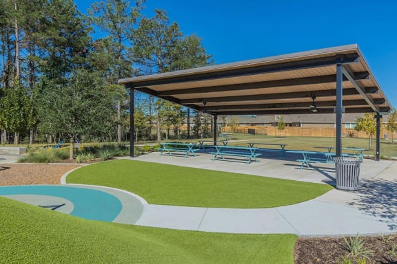 a picnic area with benches and a pool