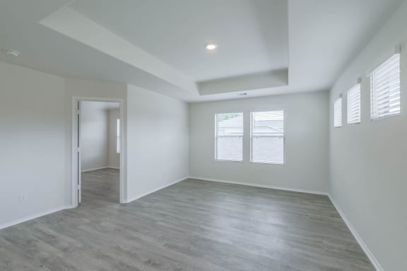 the spacious living room and dining room in a new home