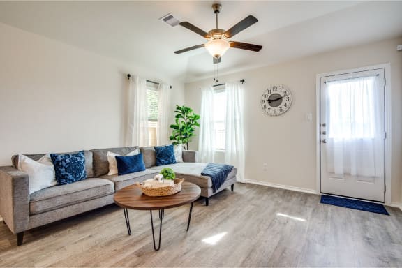 a living room with a ceiling fan and a couch