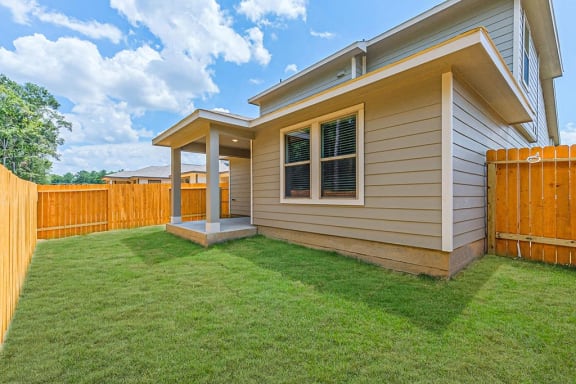 a house with a wooden fence in front of it