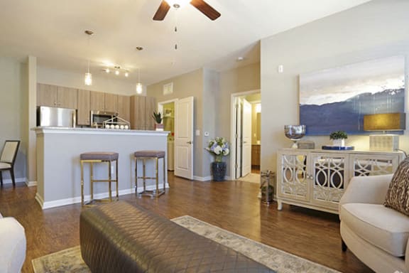 a living room and kitchen with a couch and a bar