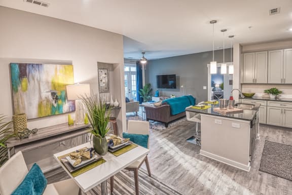 a living room with a kitchen and a dining table
