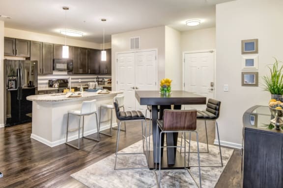 an open kitchen and dining area with a table and chairs