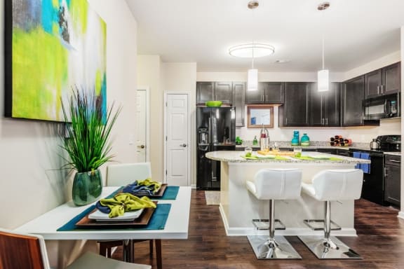 a kitchen and dining room with a table and chairs