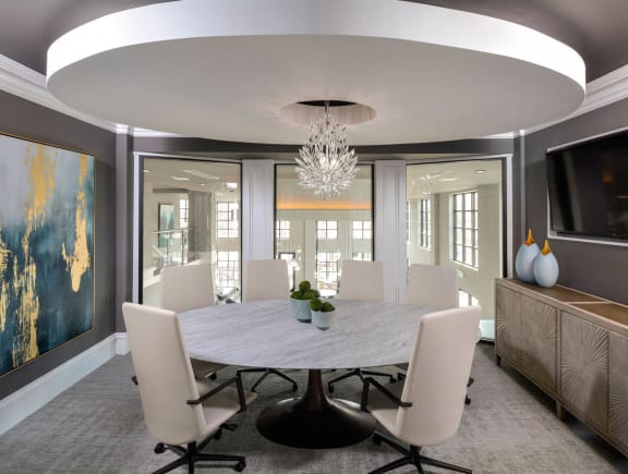 a dining room with a table and chairs and a chandelier
