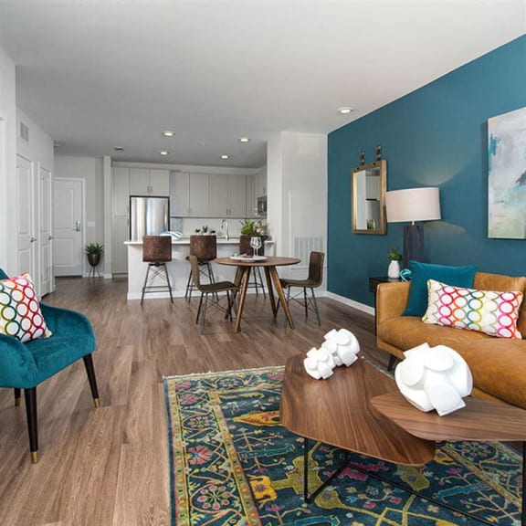 a living room and kitchen with a table and chairs