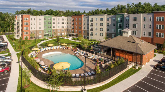 an aerial view of an apartment building and a swimming pool